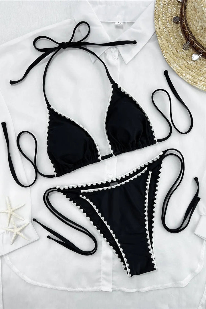 A black string bikini with white scalloped trim polyester fabric with padded cups 