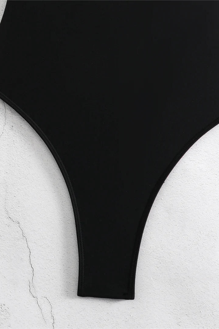 A close-up of a black high-cut monokini bottom 