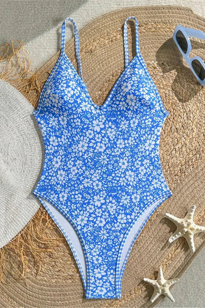 A one-piece padded swimsuit with a blue and white floral pattern