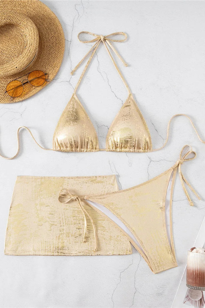 A three-piece metallic gold bikini set Coordinated mini skirt adds versatile coverage