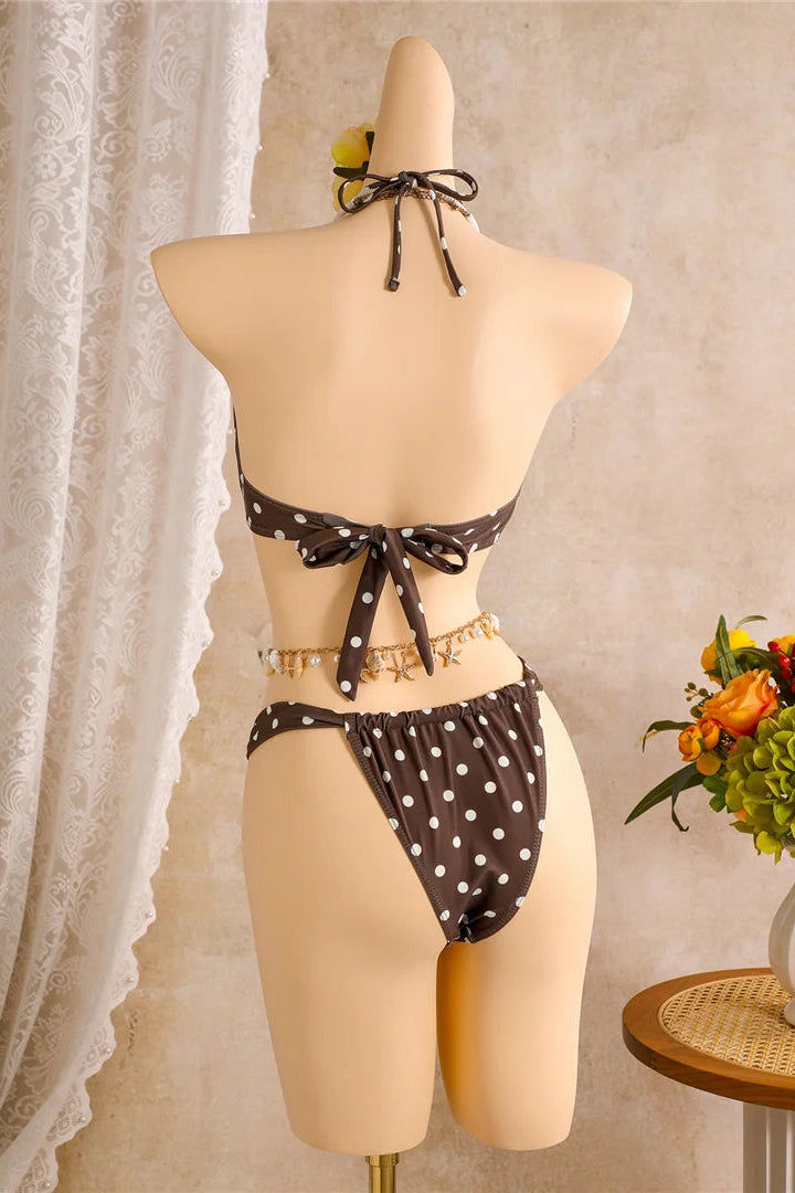 A two-piece bikini set with a dark brown and white polka dot pattern 