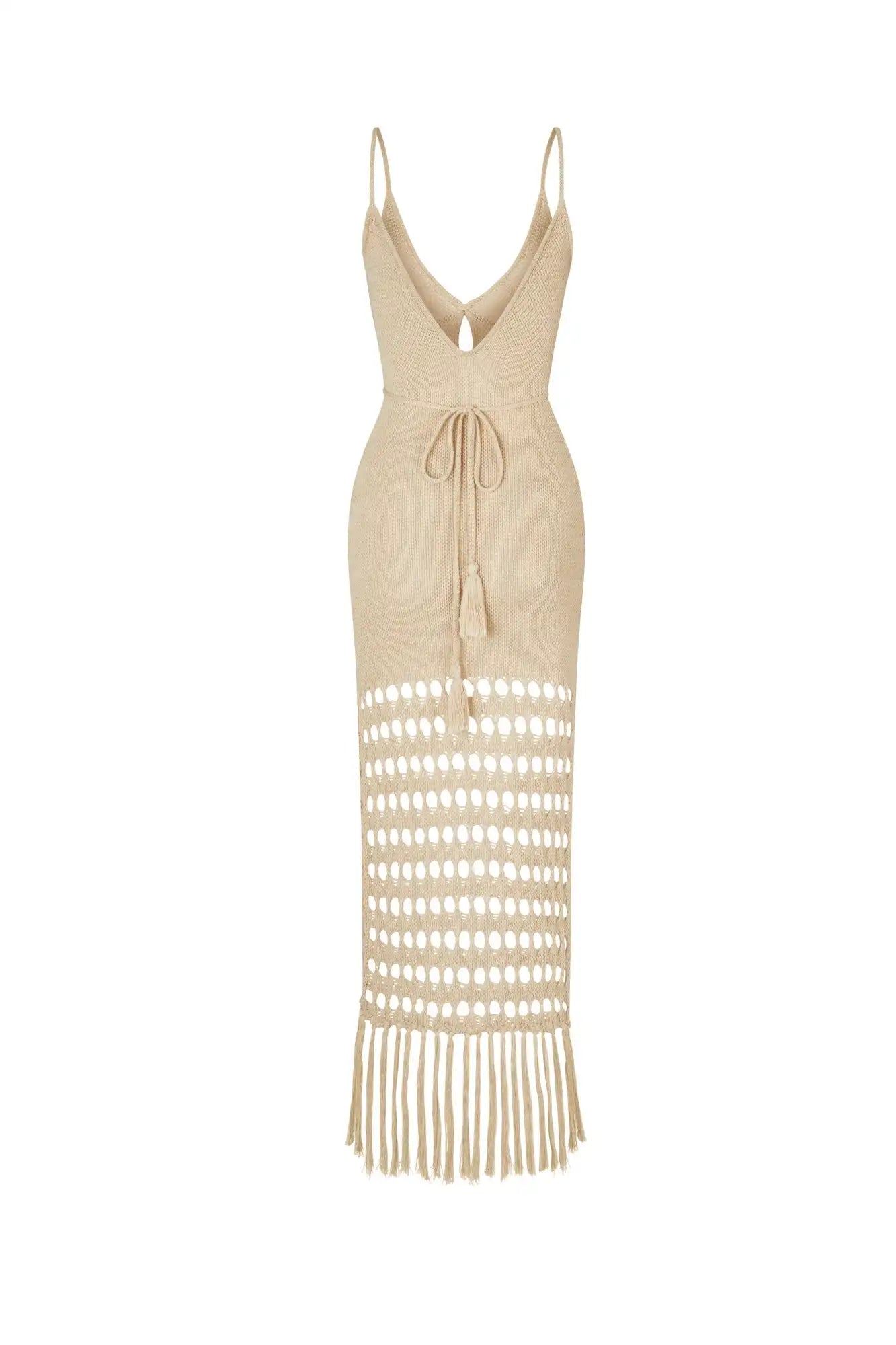 Beige dress with cut-out design and fringes on a white background