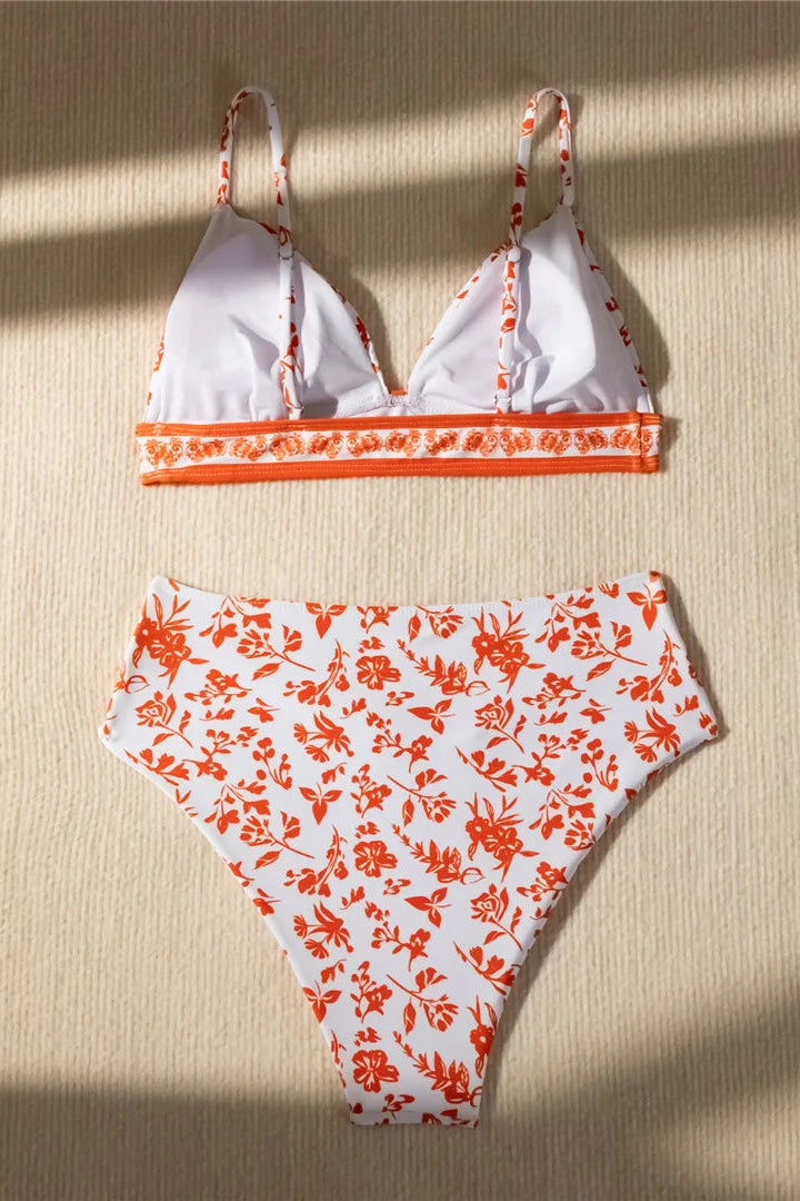 Bikini set with orange floral pattern on a beige background
