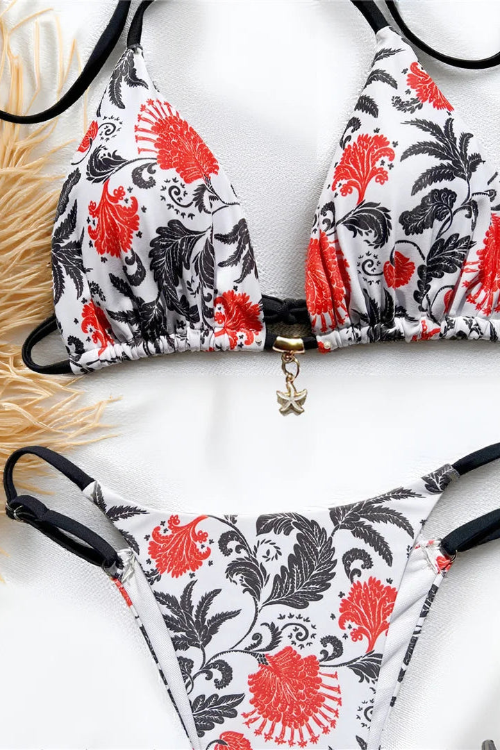 Bikini set with red and black floral pattern on a white background