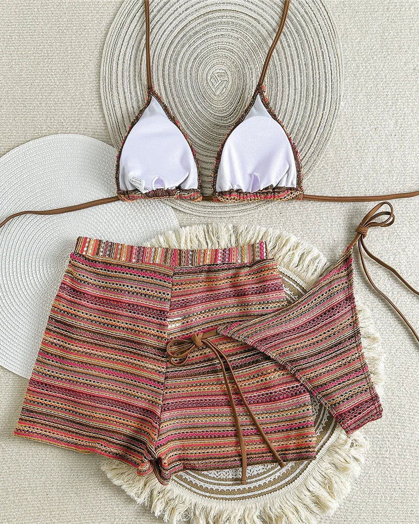 Bikini set with striped shorts and top on a textured surface