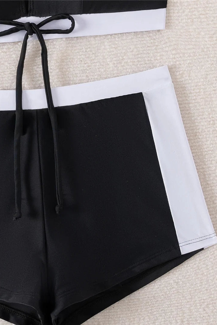 Black and white shorts with a drawstring on a textured surface