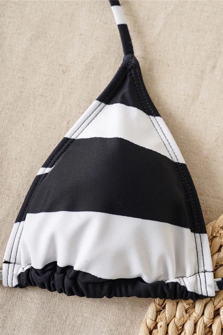 Black and white striped bikini top on a beige background