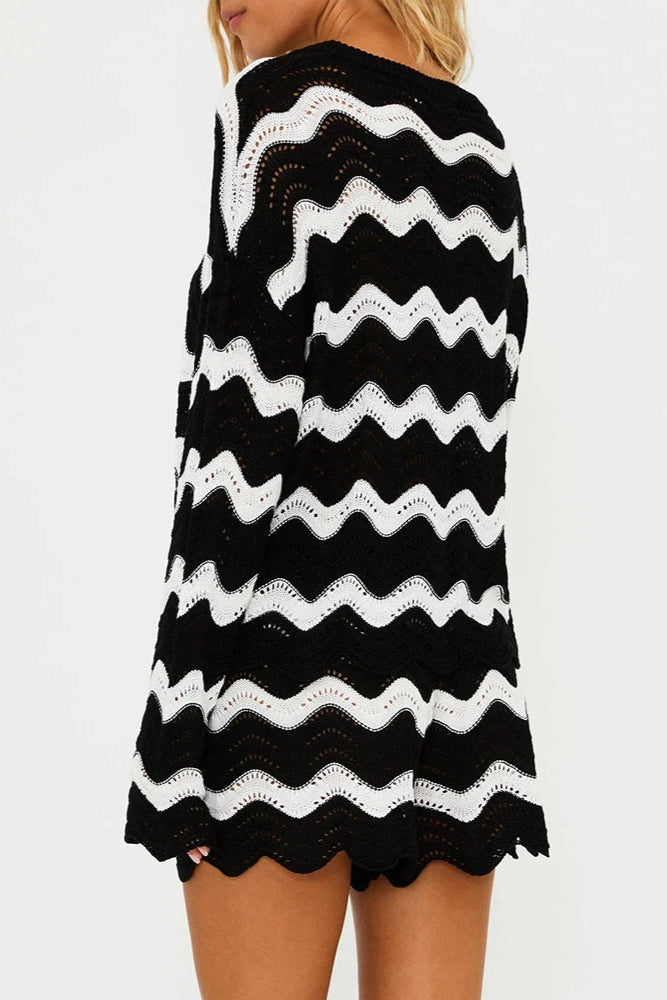 Black and white striped cover up top on a plain background