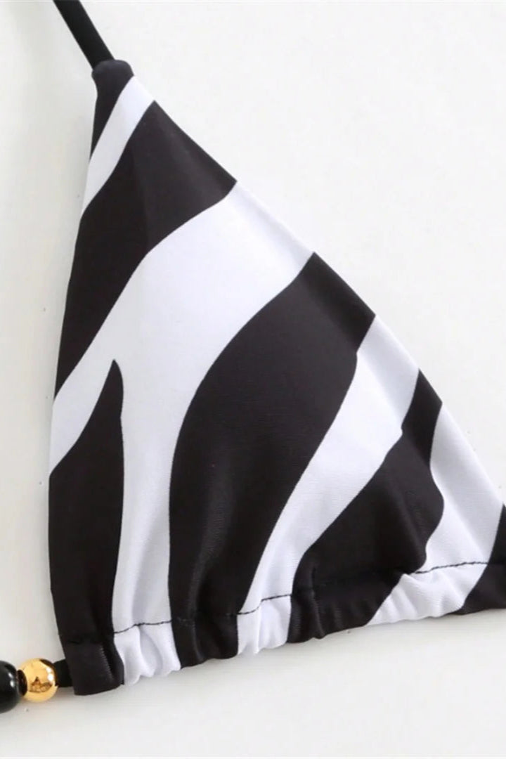 Black and white striped swimsuit bikini top on a white background