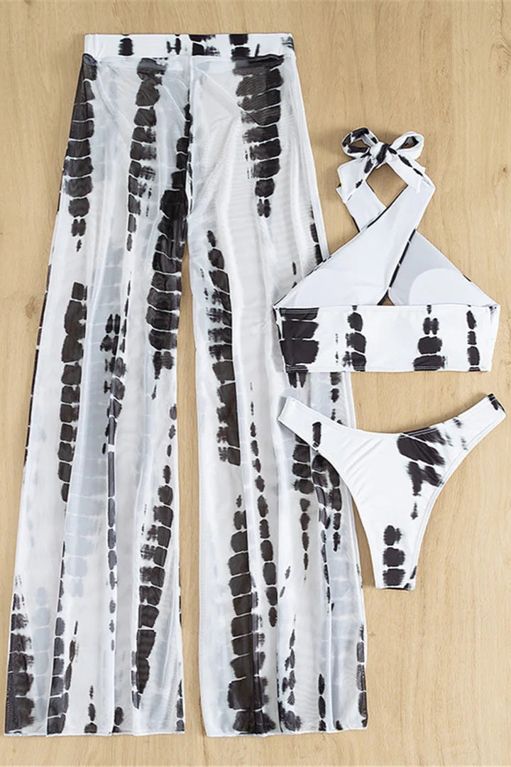 Black and white tie-dye pants with matching bikini set on a beige background