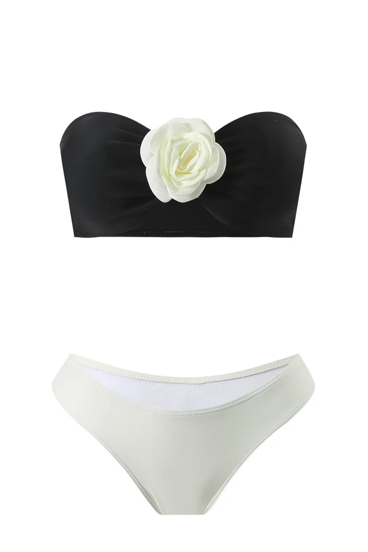 Black bandeau bikini top with a white flower includes pads for comfortable support and a feminine touch ideal for bikini swimwear.