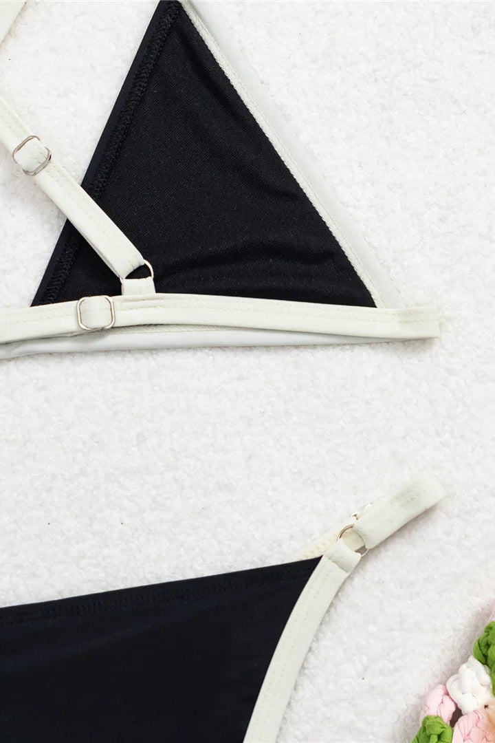 Black bikini bottom with white straps.
