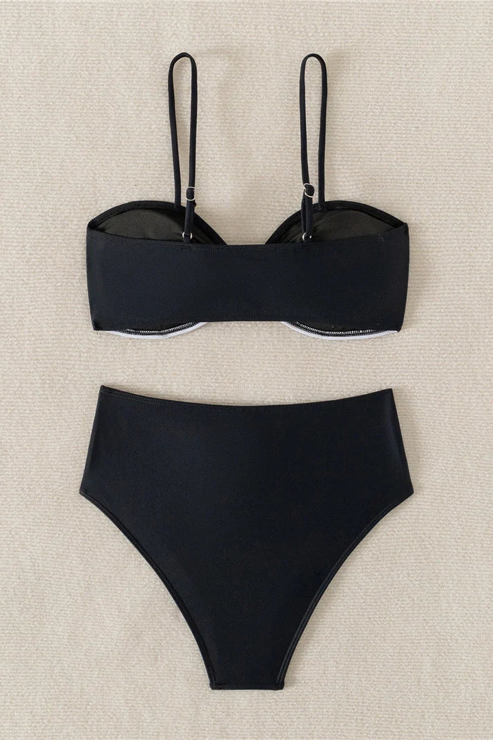 Black bikini set on a beige textured background