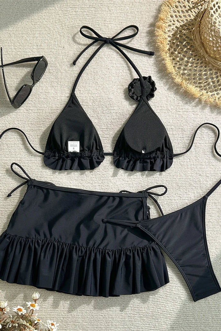 Black bikini set with ruffled details and mini skirt cover up