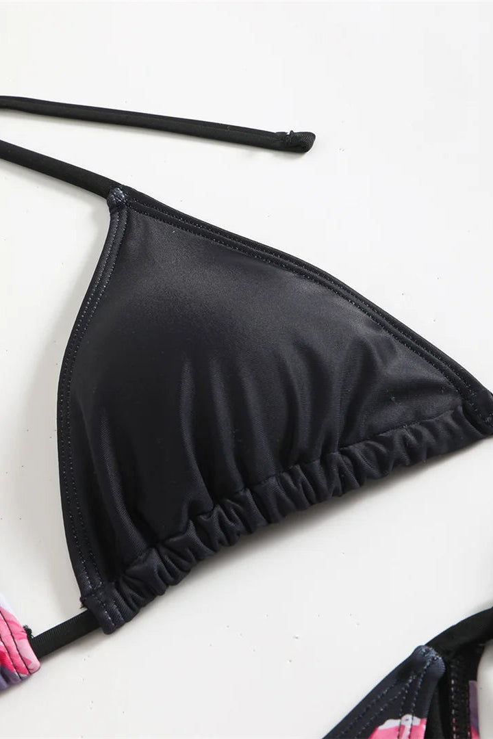 Black bikini top with floral bottom on a white background