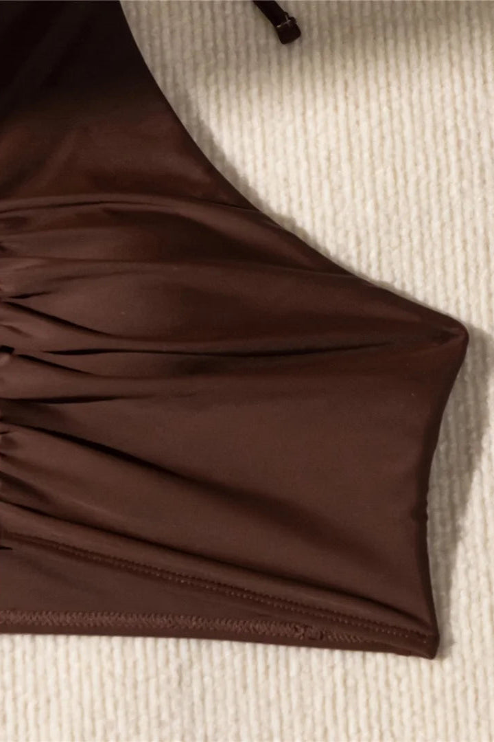 Brown bikini on a textured beige surface dcostaa swimwear 