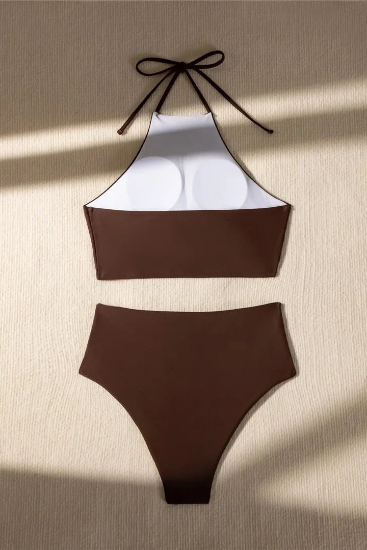 Brown bikini set with white top on a beige background