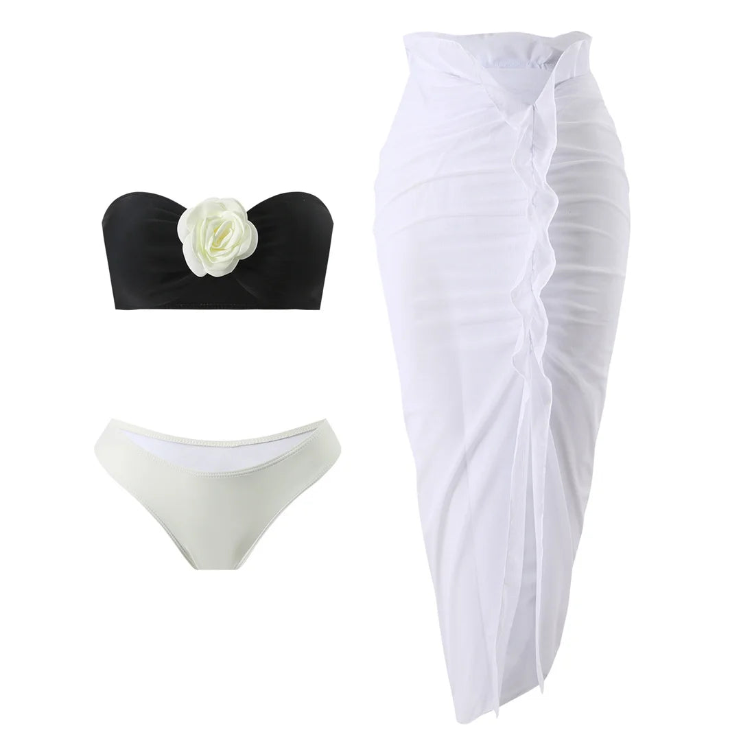 Chic three-piece bikini set featuring wire-free 3D flower bandeau top with pads low-waist bottom  and sheer mesh skirt with middle front slit in white 
