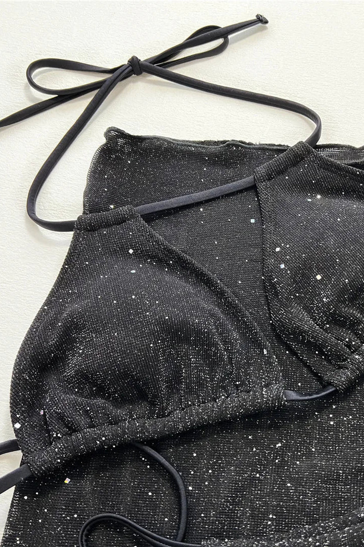 Close-up of a black sparkly bikini set garment with thin black tie straps