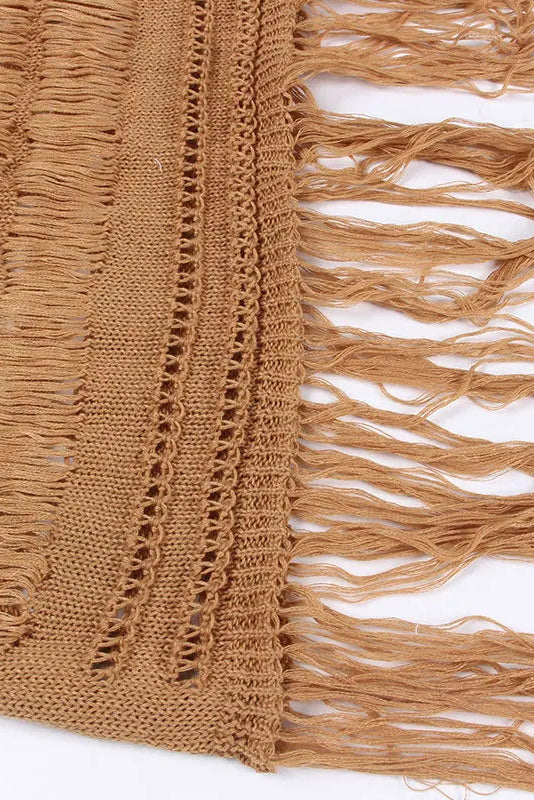 Close-up of a brown knitted fabric with fringes on a white background