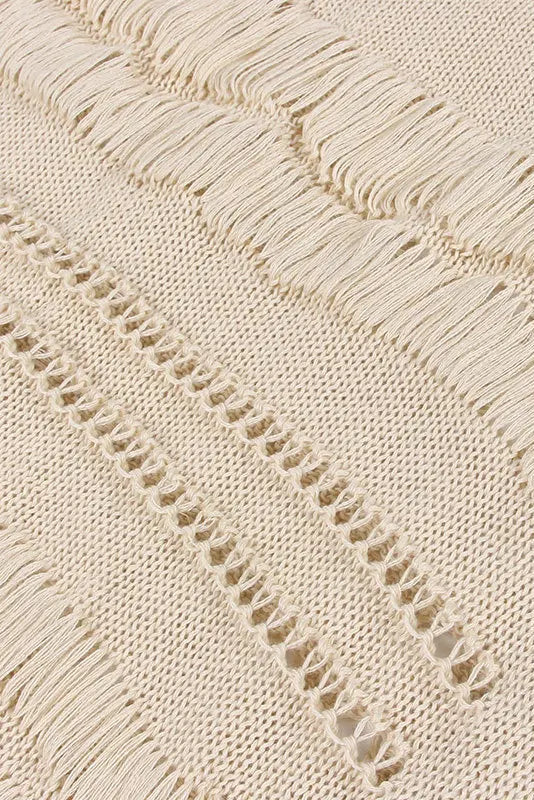 Close-up of a textured beige fabric with a subtle pattern on a light background
