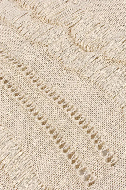 Close-up of a textured beige fabric with a subtle pattern on a light background