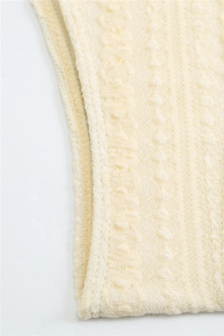 Close-up of a textured cream-colored bikini bottom