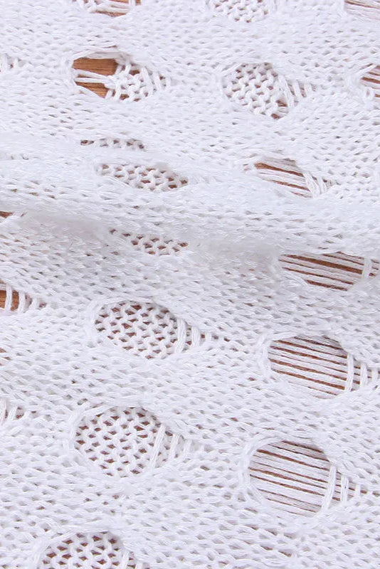 Close-up of white lace fabric with wooden beads