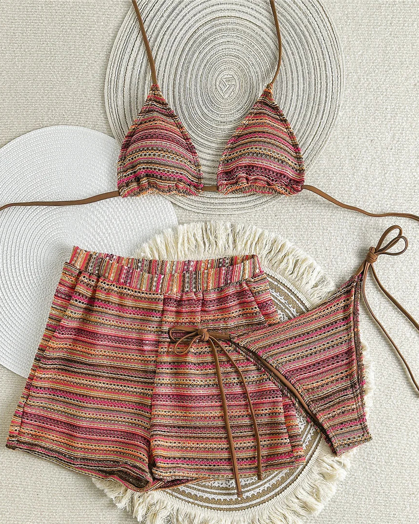 Colorful bikini set with matching shorts on a textured surface