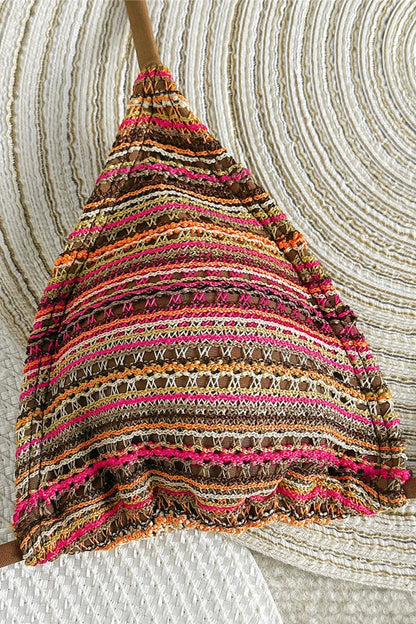 Colorful striped bikini top against a textured beige background