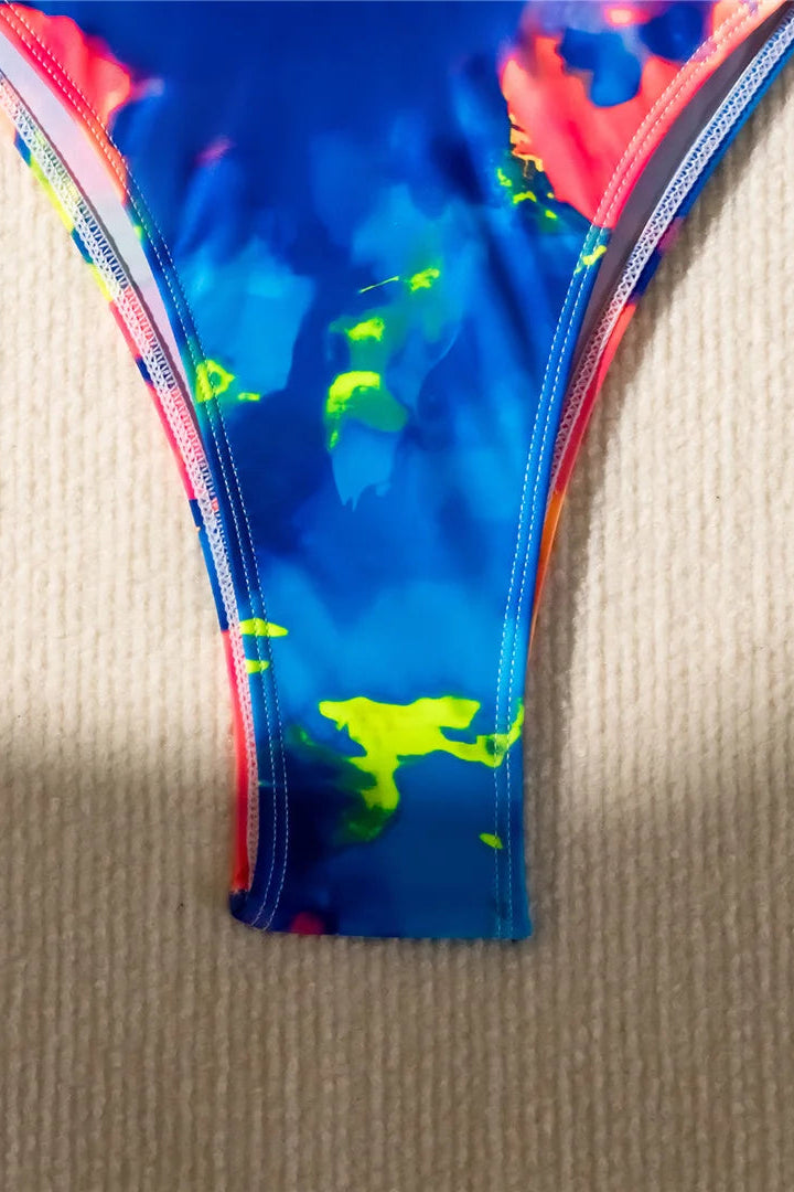 Colorful swim bottom with blue, red, and green design on a beige surface
