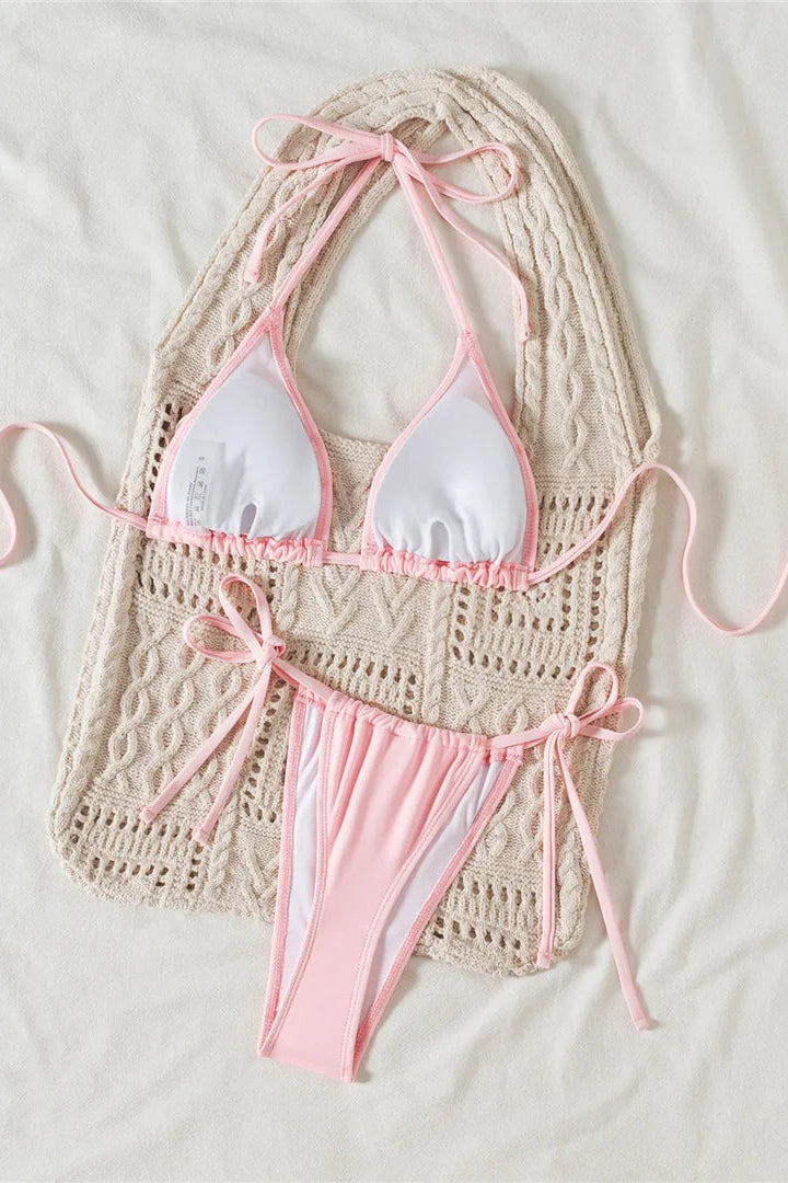 Crocheted bikini top and pink bottom on a light background