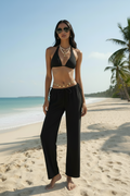 Elegant black bikini set featuring a coordinated three-piece design for timeless beachwear and chic resort wear styling.