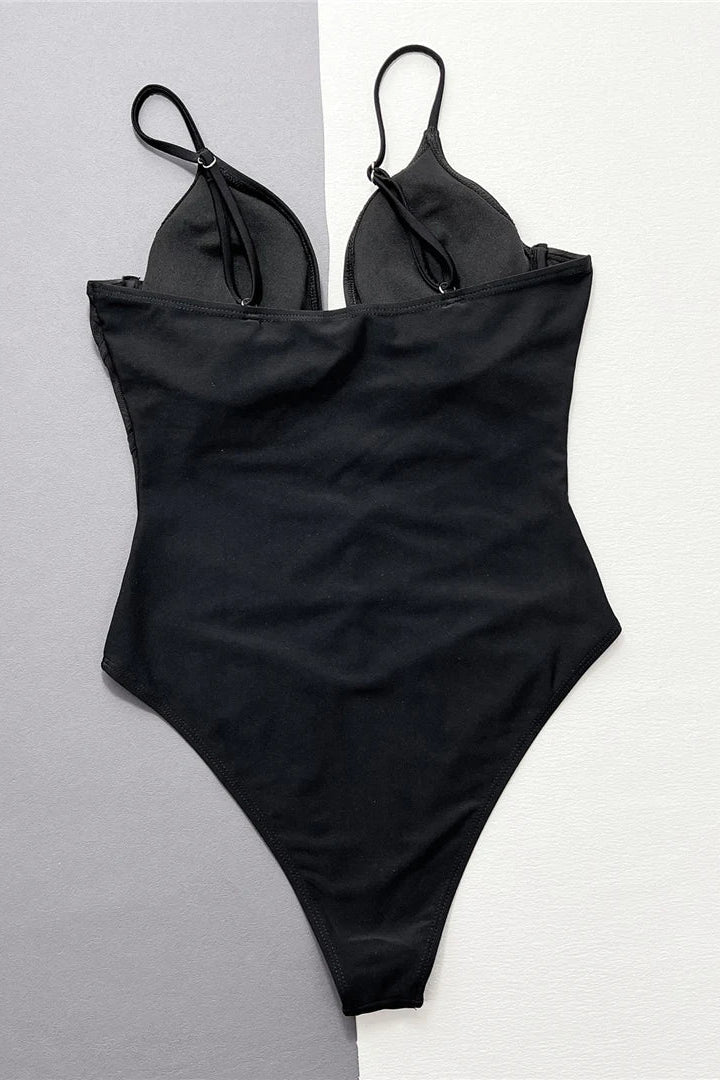 Elegant solid one-piece swimsuit featuring a flattering V-neckline and sheer splicing details.