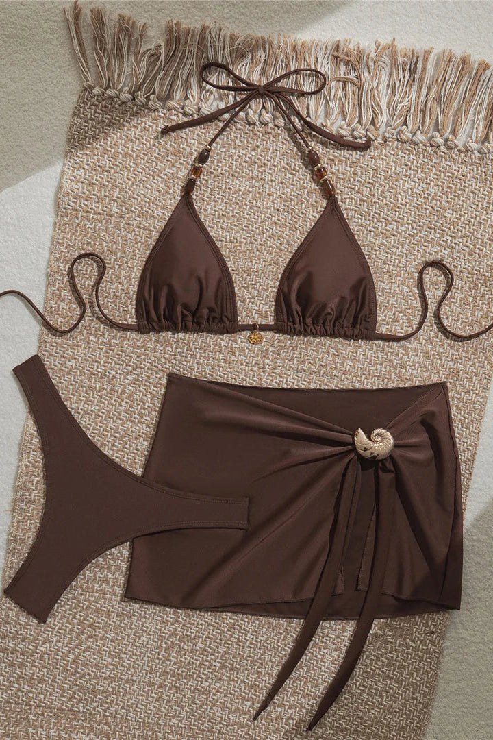 Flattering halter neckline creates a feminine and stylish swimwear silhouette perfect for beach days and vacations.