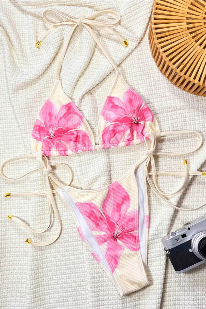 Floral bikini set with a camera and basket on a textured surface