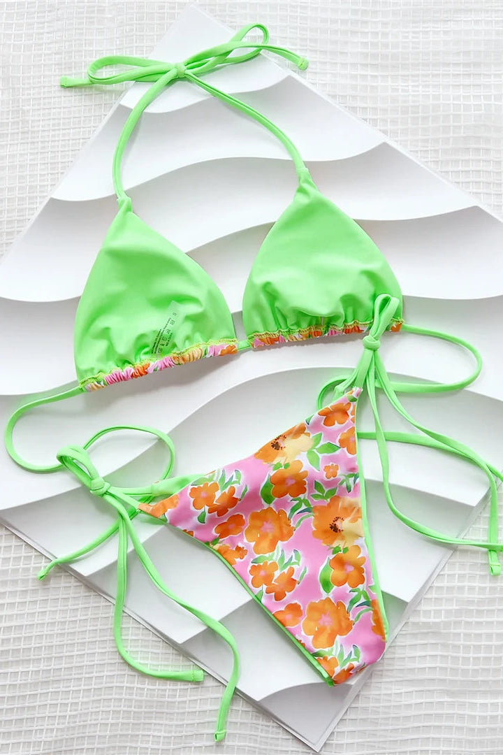Floral bikini set with green straps on a white background
