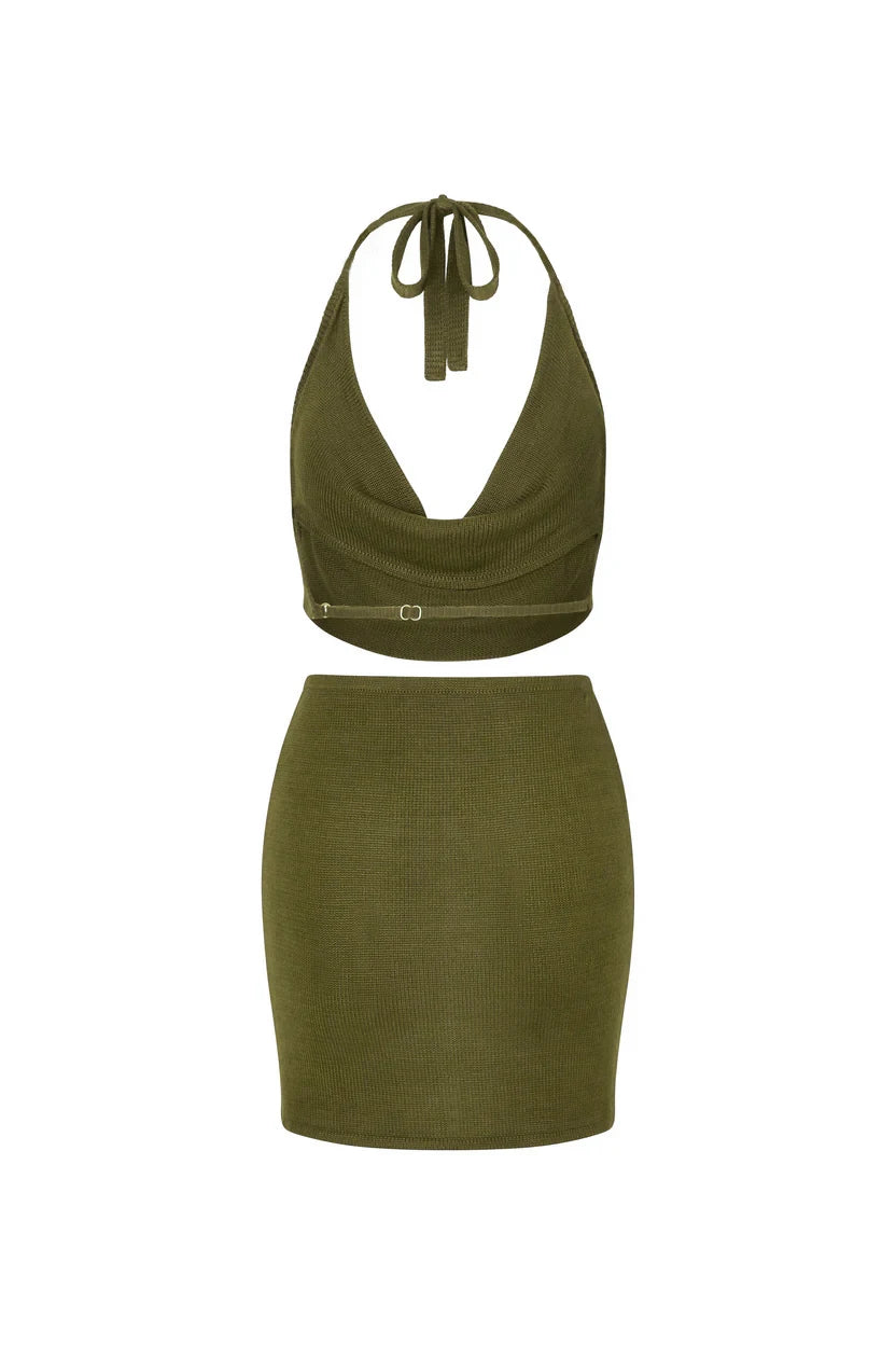 Green two-piece outfit with halter top and skirt on a white background