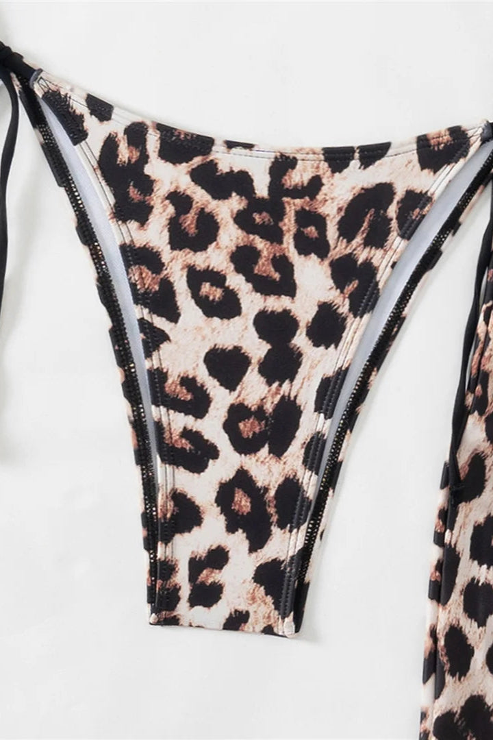 Leopard print bikini bottom with a black tie on a white background