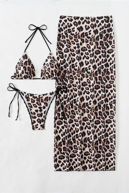 Leopard print bikini set with matching cover up skirt on a white background