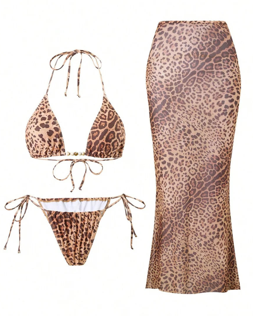 Leopard print bikini set with matching skirt cover up on a white background