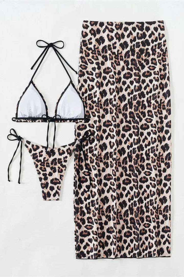 Leopard print bikini set with matching skirt on a white background