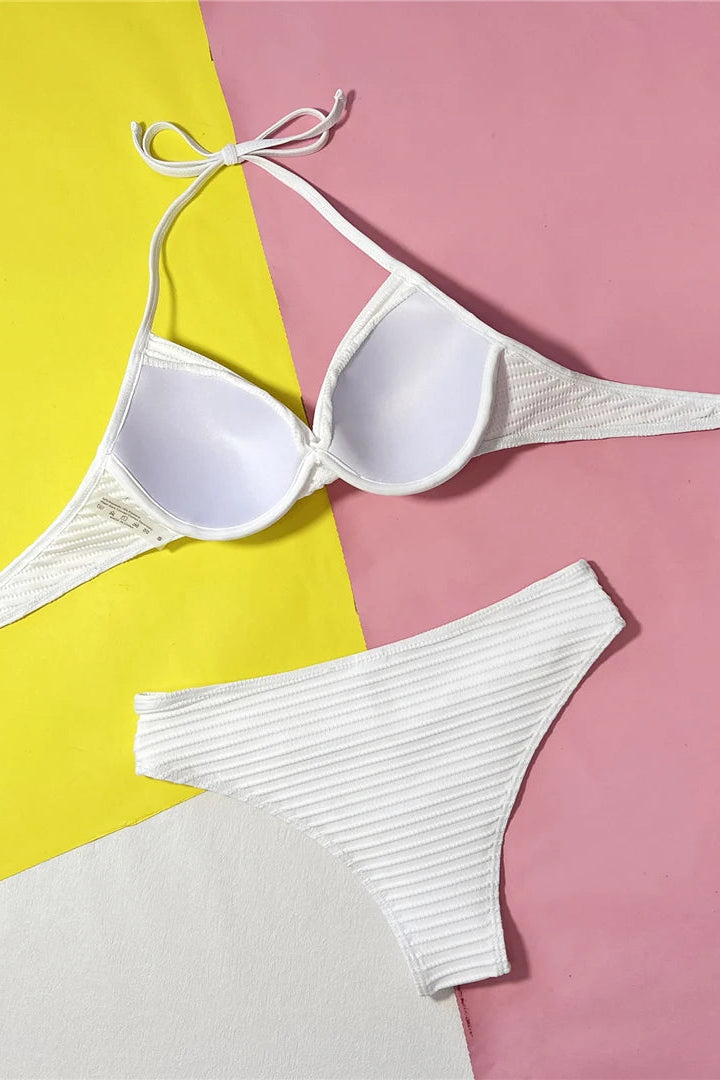 Padded under wire halter neck white bikini set ideal for vacations, tropical getaways, and summer swimwear.
