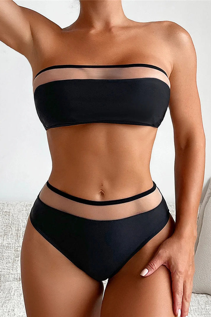 Person wearing a black bikini set on a neutral background