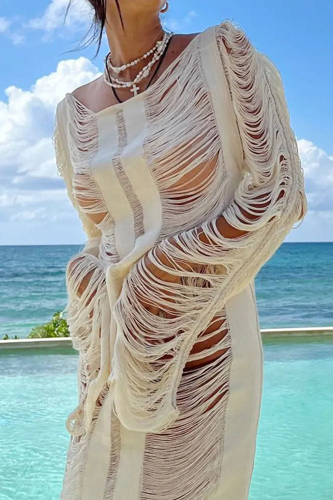 Person wearing a white, ruffled dress with a scenic ocean view in the background