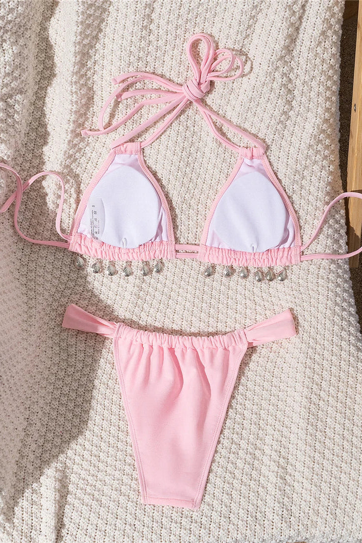 Pink bikini set on a textured surface