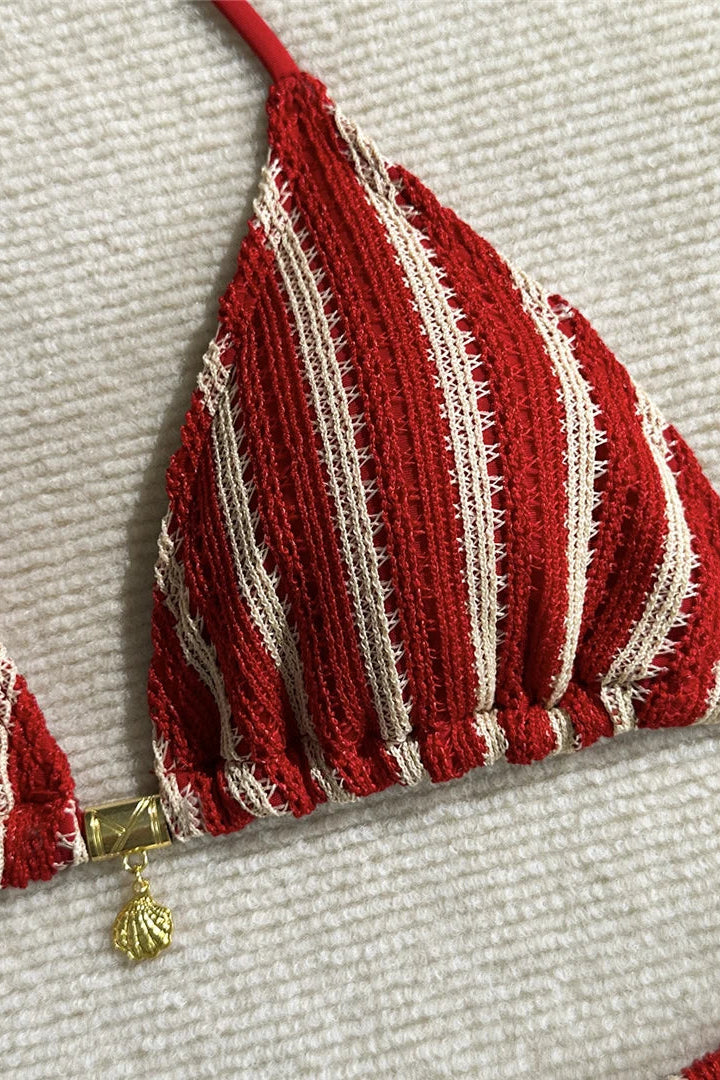 Red and white striped bikini top on a textured beige background
