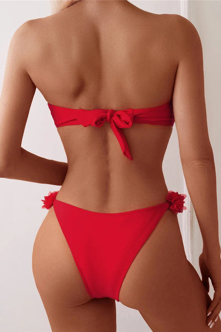 Red bikini with floral details on a plain background