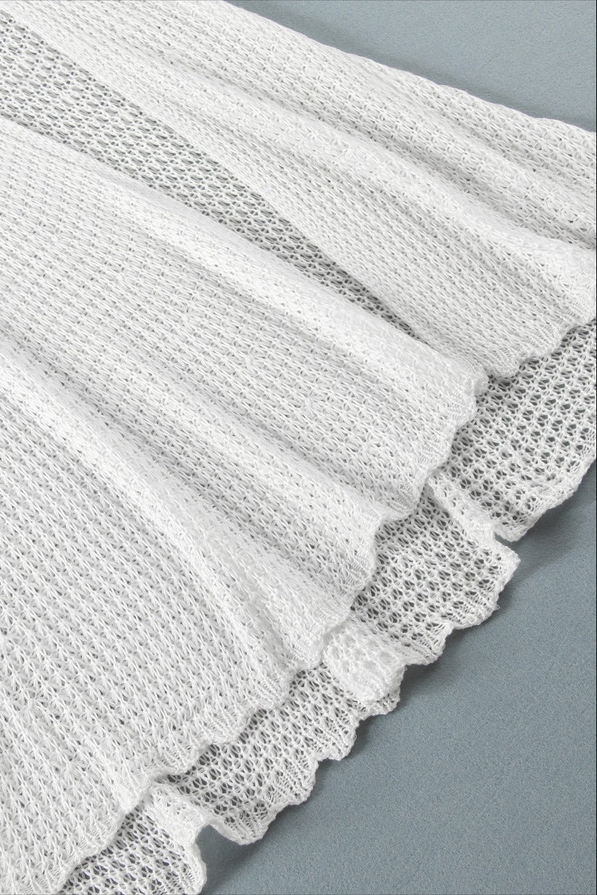 Textured white maxi dress fabric on a gray background