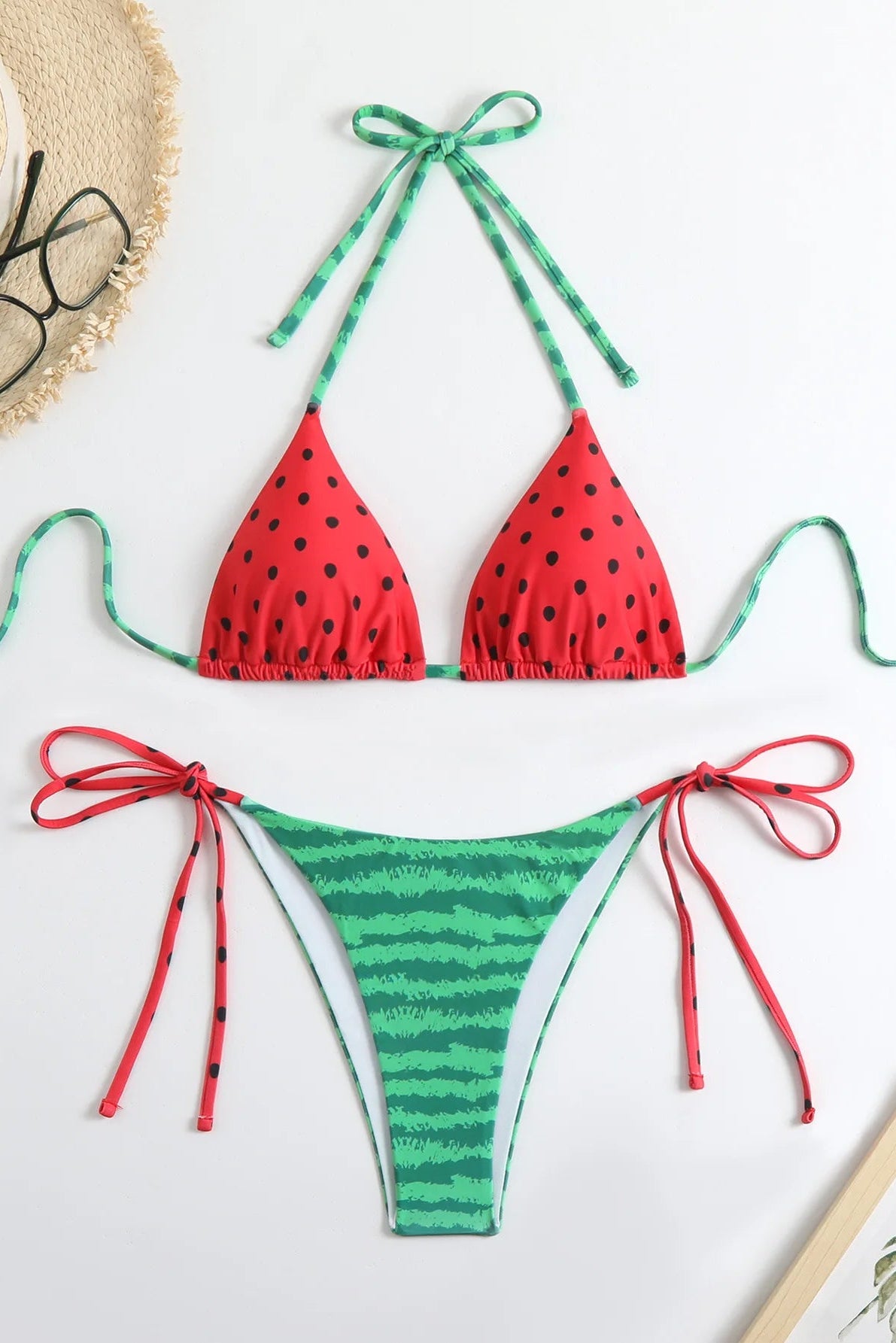 This image features a vibrant and stylish Watermelon Dot Bikini Set, perfect for beach outings or poolside lounging. The bikini is designed with a bold red top adorned with a playful watermelon dot pattern and a contrasting green bikini bottom, creating a eye-catching and cheerful look.